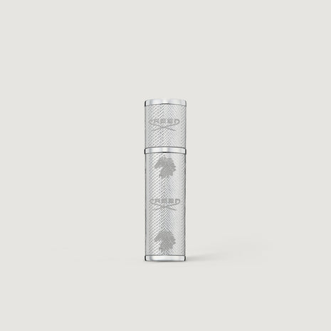 Creed silver leather 5ml perfume atomizer on a light gray background