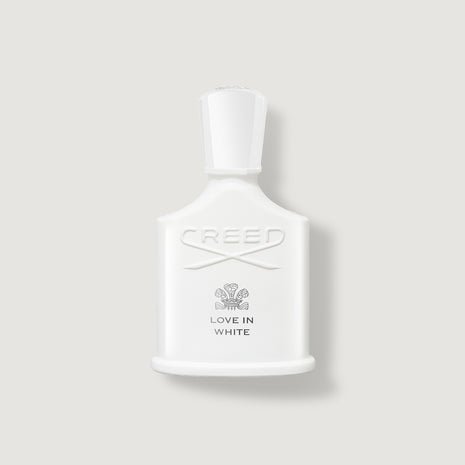 Creed Love in White perfume bottle on a light gray background